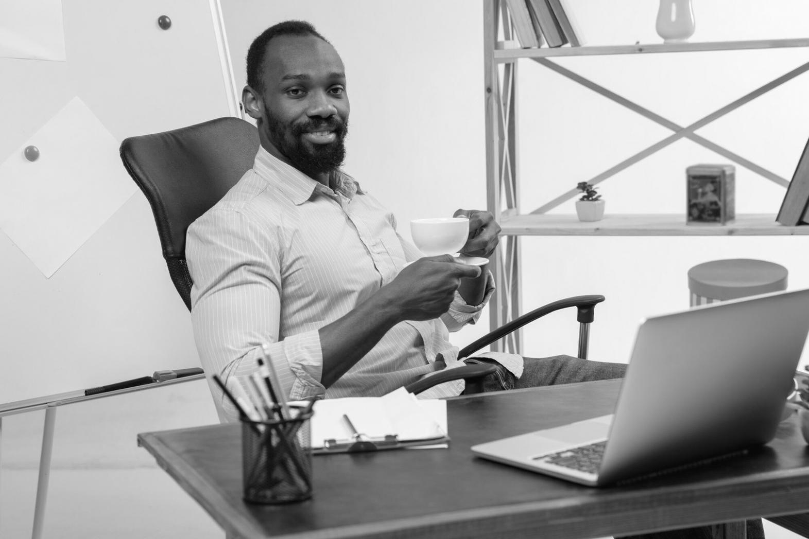 Close-up of hands writing in a planning journal with structured goal frameworks